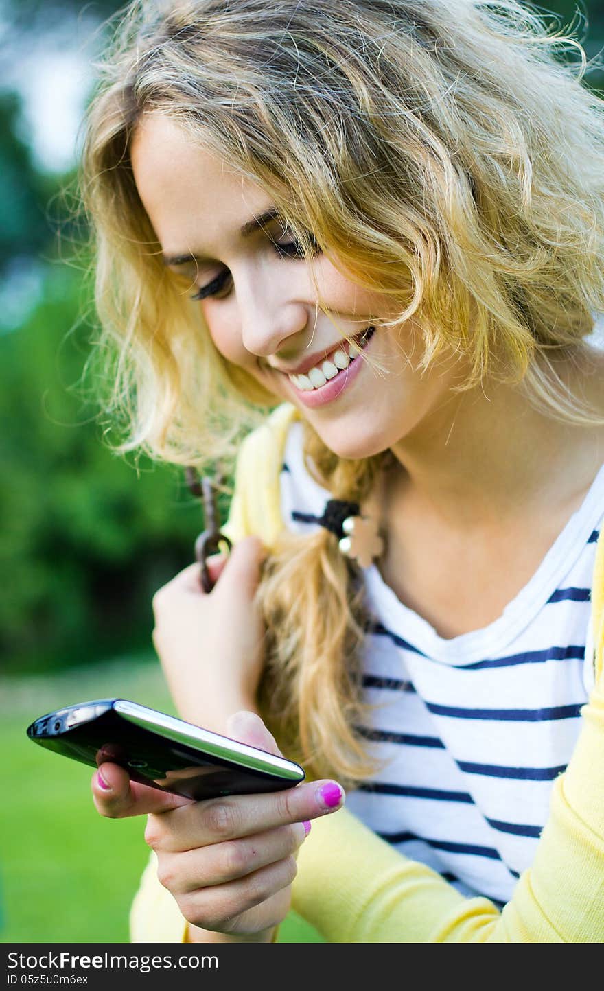 Portrait of young blonde girl at the park