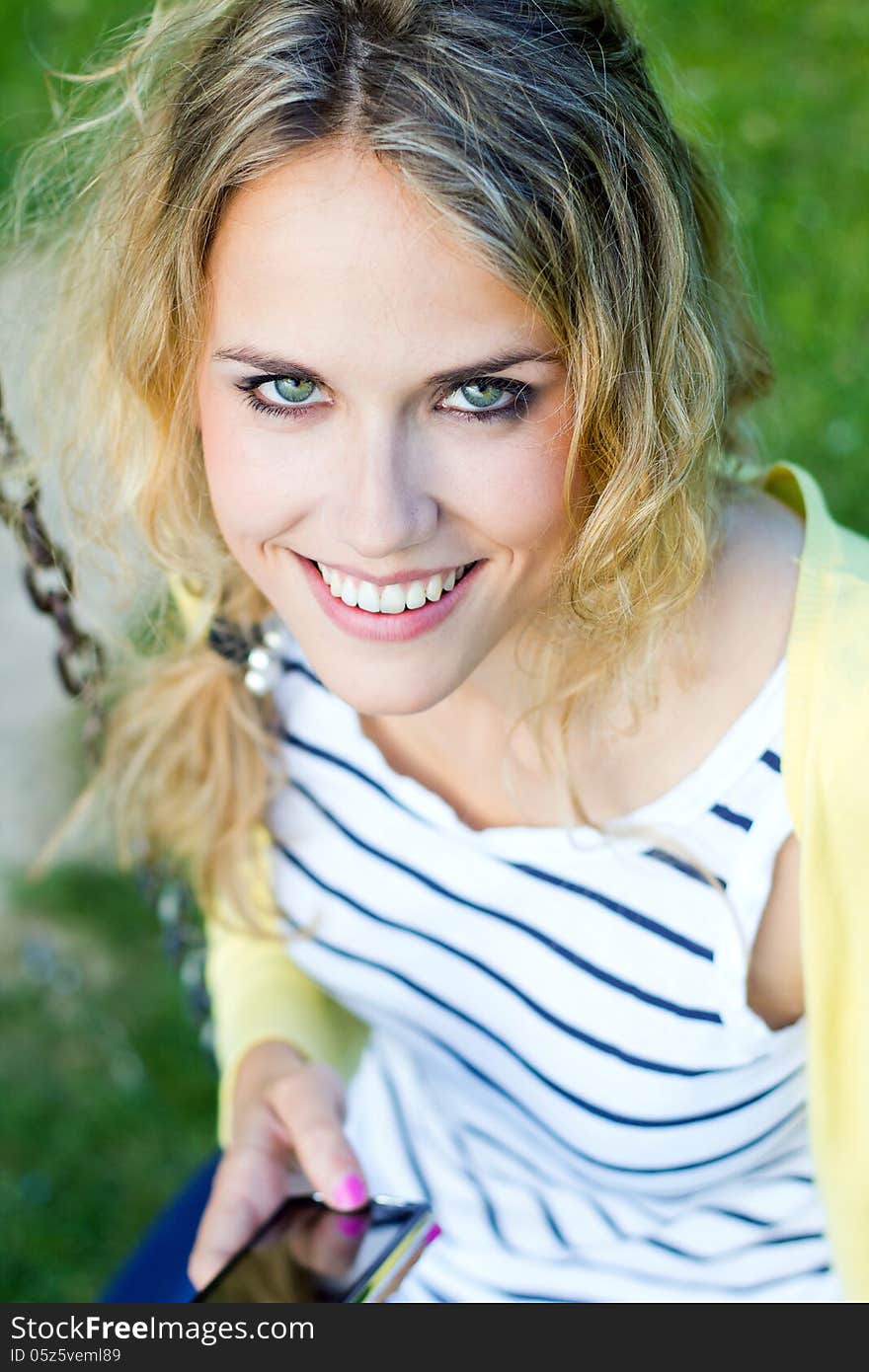 Portrait of young blonde girl at the park