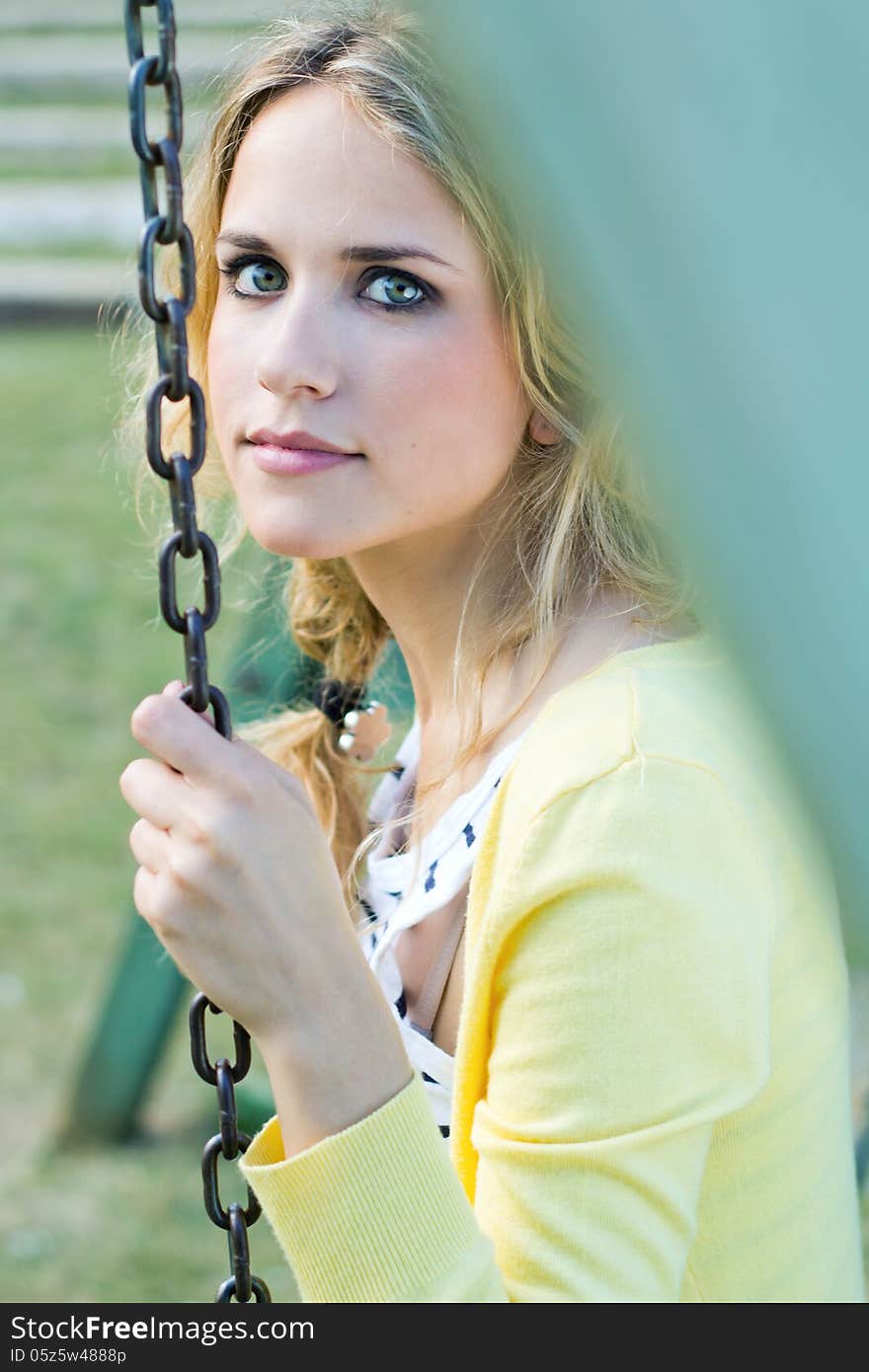 Portrait of young blonde girl at the park