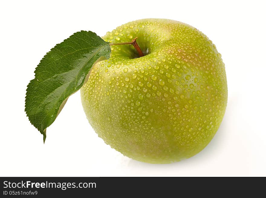 Green apple with water drops on a white background