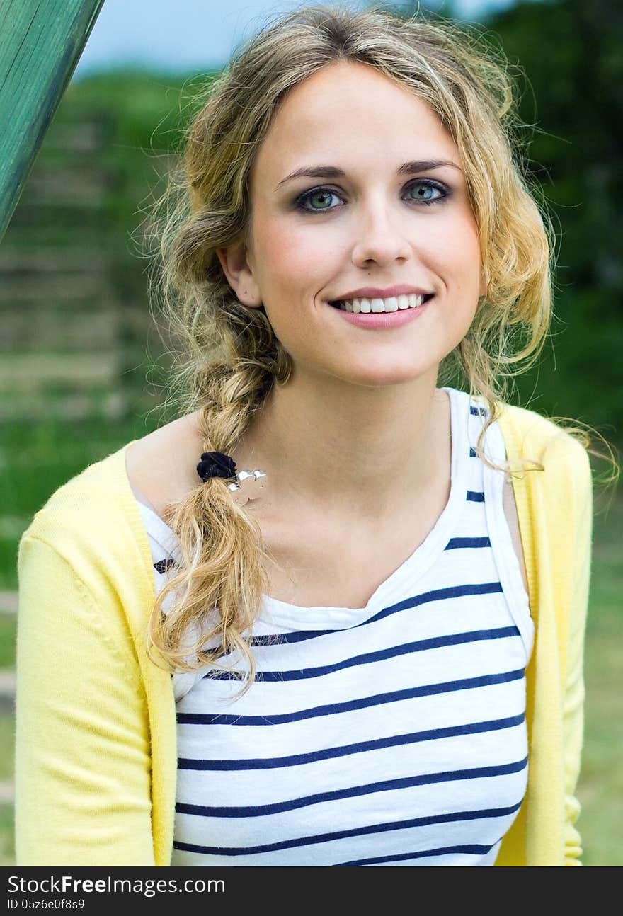 Portrait of young blonde girl at the park