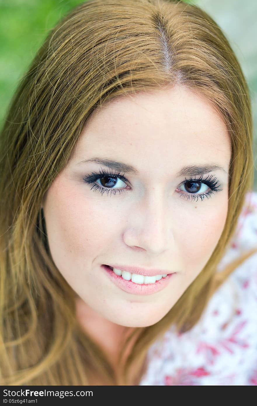 Portrait of young blonde girl at the park