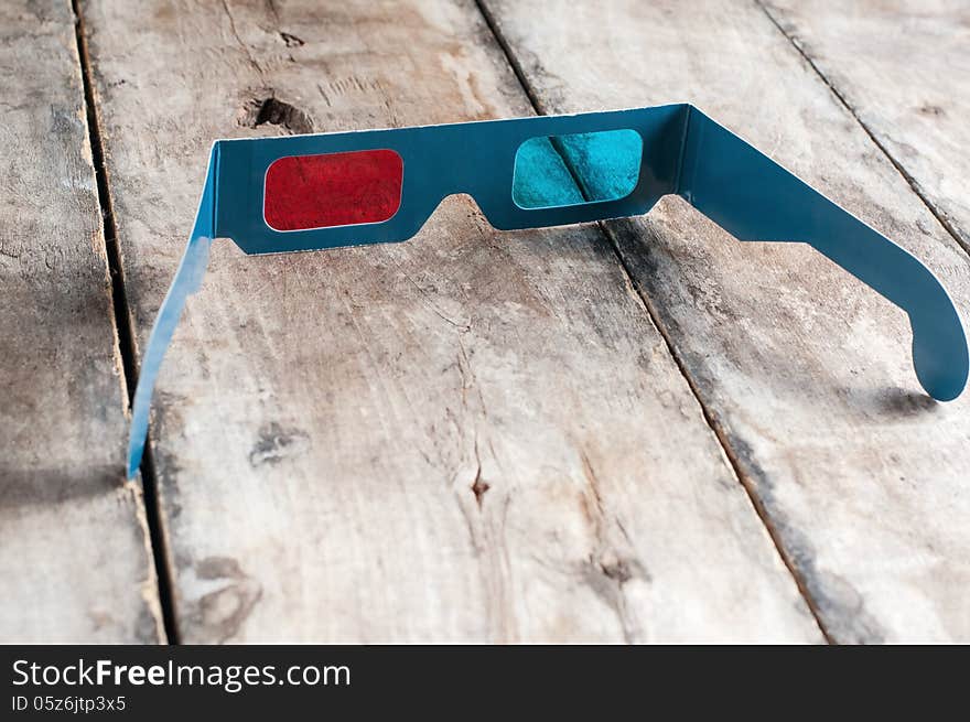 3d glasses on wooden table, close up photo