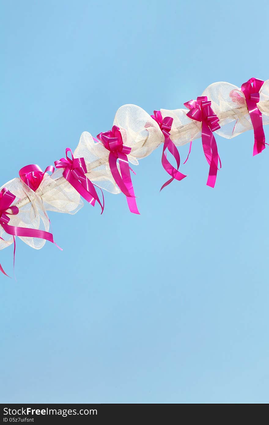 White and pink festive decoration with cloudless blue sky