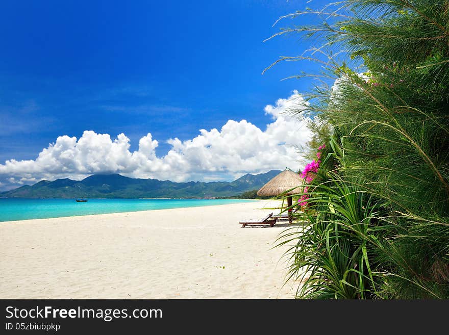 Tropical paradise beach with white sand on a background of mountains. Vietnam