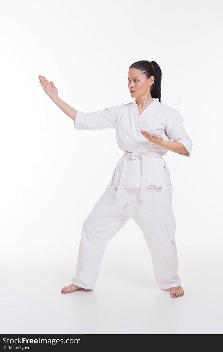 Beautiful woman in kimono show martial art exercise on white. Beautiful woman in kimono show martial art exercise on white