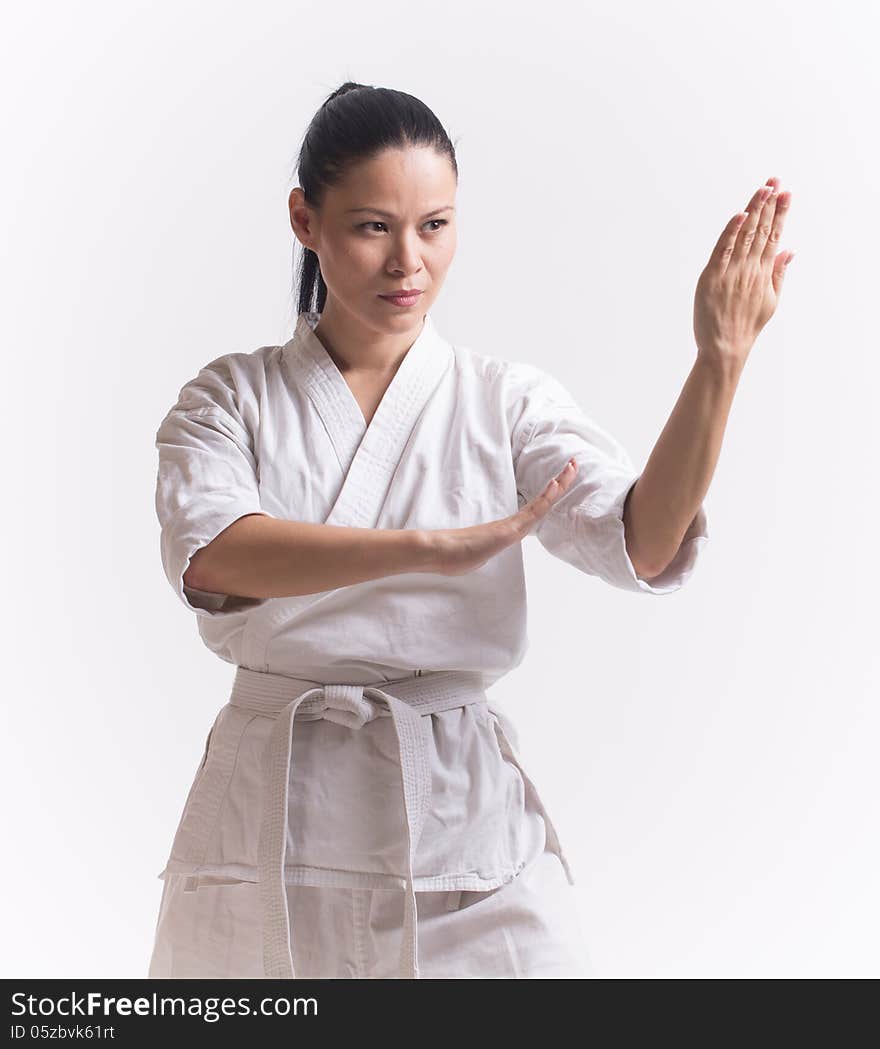 Woman in kimono show block in martial art on white. Woman in kimono show block in martial art on white