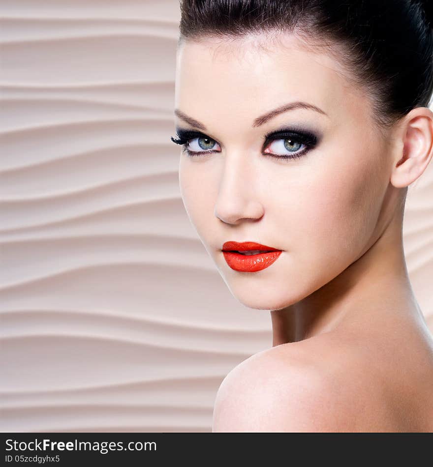 Young beautiful woman with red lips