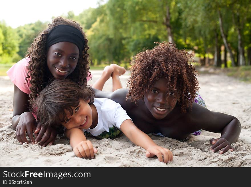 Smiling ethnic children on the beach