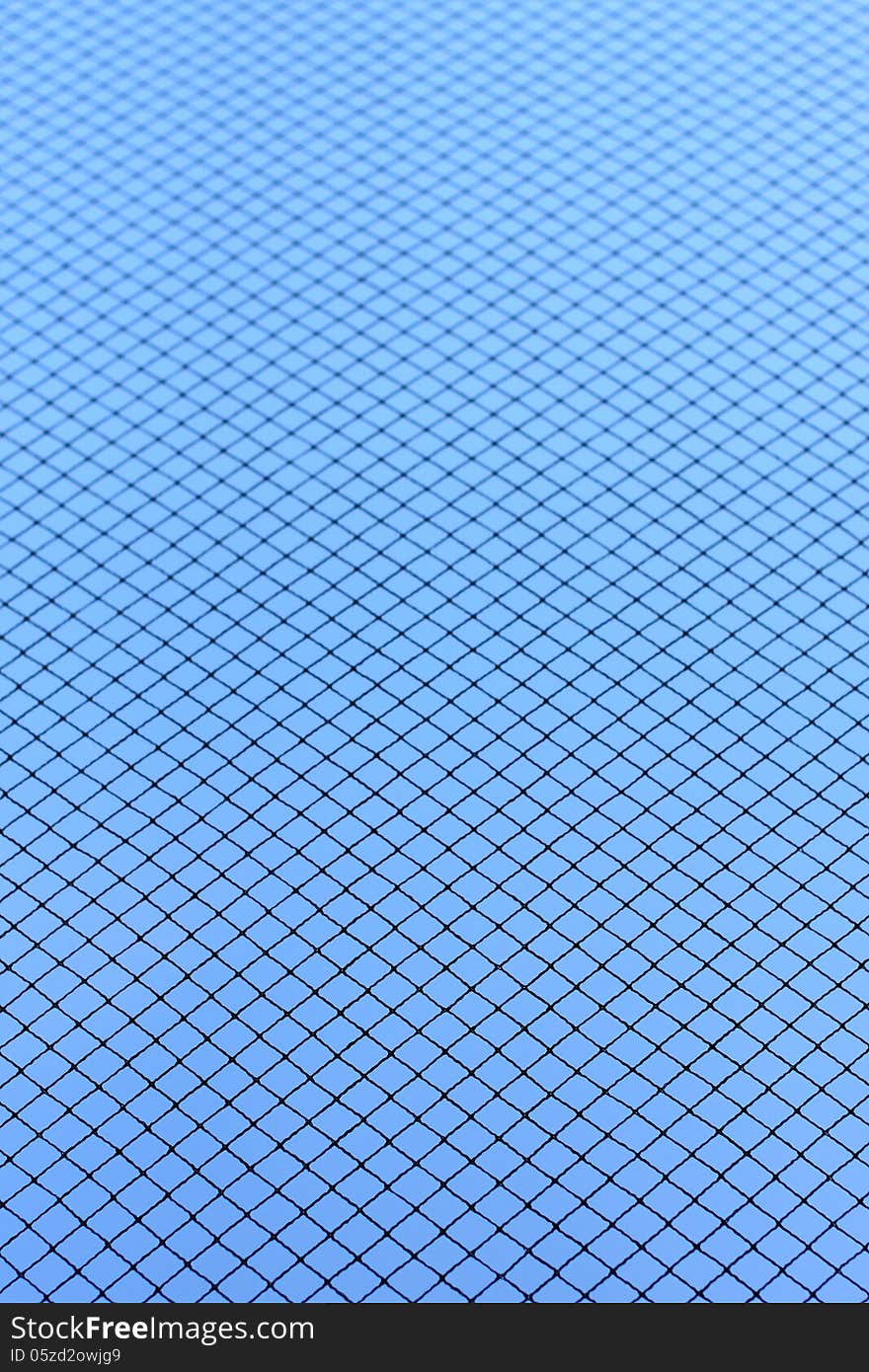 Real mesh structure on blue sky background focused at one third and gradient to out of focus. Real mesh structure on blue sky background focused at one third and gradient to out of focus