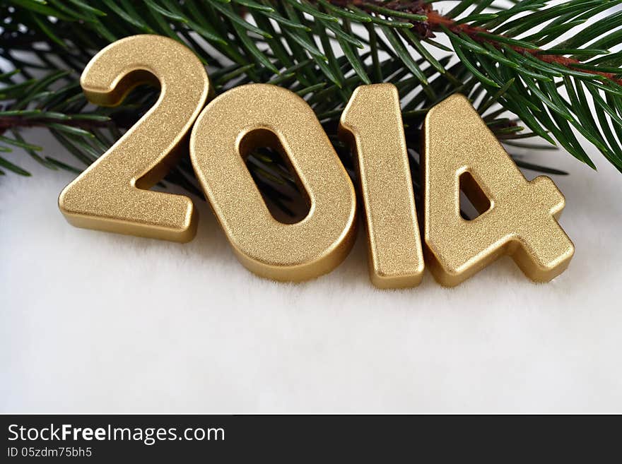 2014 year golden figures on a spruce branch