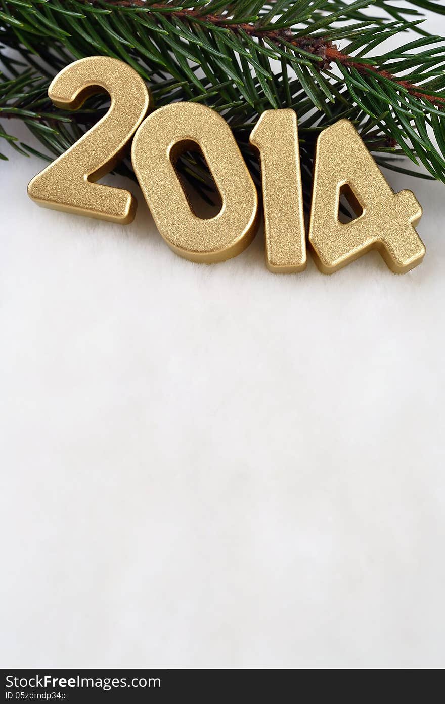 2014 year golden figures on a spruce branch