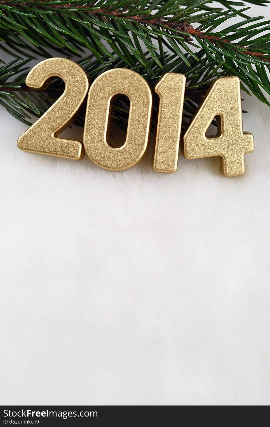 2014 year golden figures on a spruce branch