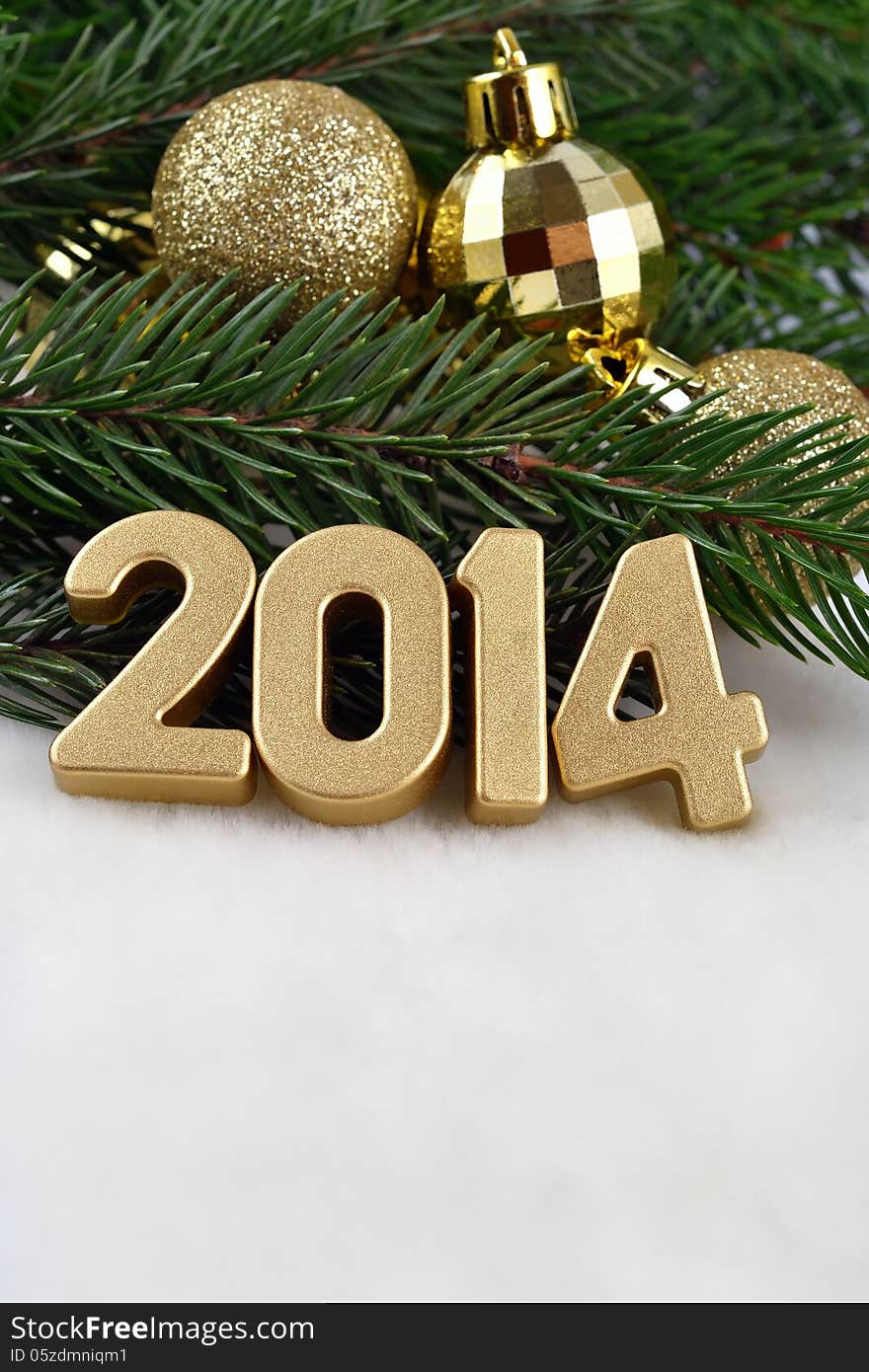 2014 year golden figures on a spruce branch