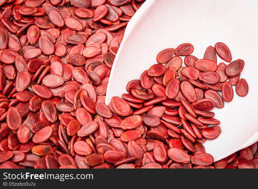 Close up of red pumpkin seeds.