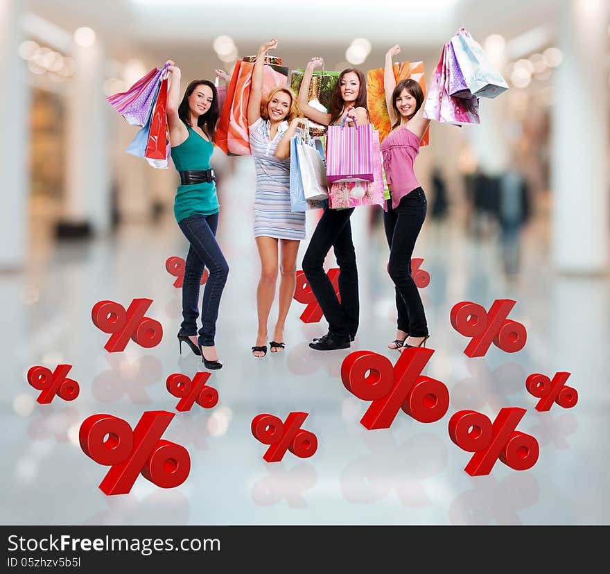 Happy women with shopping bags at store