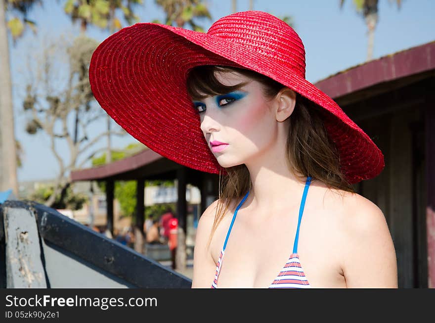 Stunning young lady with red hat posing in beautiful Newport Beach California. Stunning young lady with red hat posing in beautiful Newport Beach California.