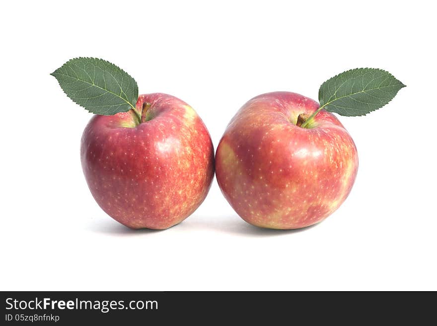 Two sweet red apple with leaf on isolated background. Two sweet red apple with leaf on isolated background