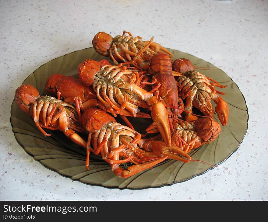 вoiled crawfish are in a plate on white table. вoiled crawfish are in a plate on white table