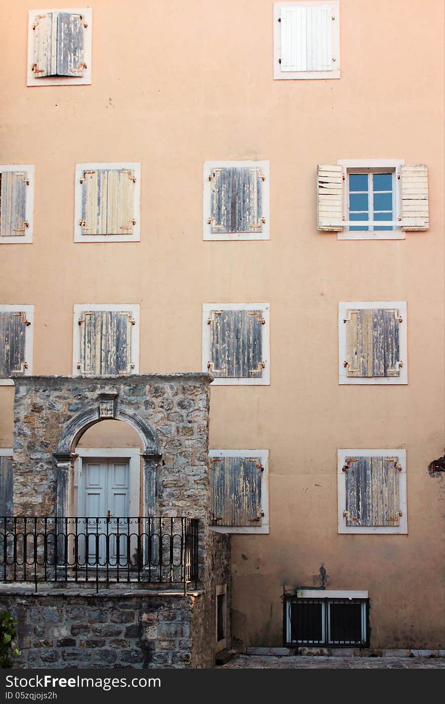 Facade of the medieval building with shutters