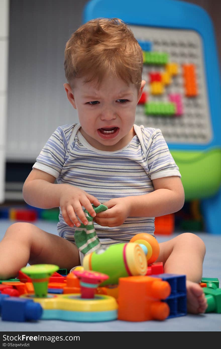 A baby boy crying in children room