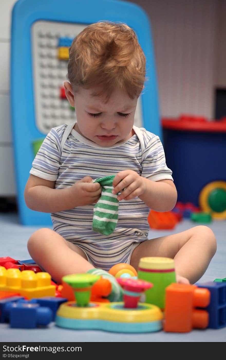 A baby boy crying in children's room