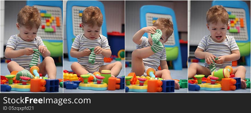 A funny baby boy trying to dress socks in children's room