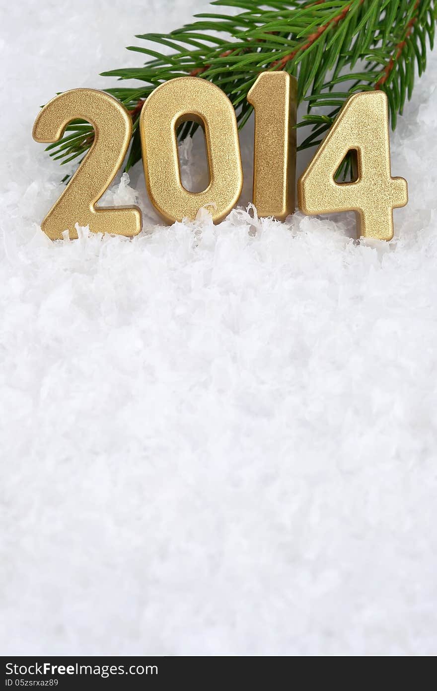 2014 year golden figures on a spruce branch