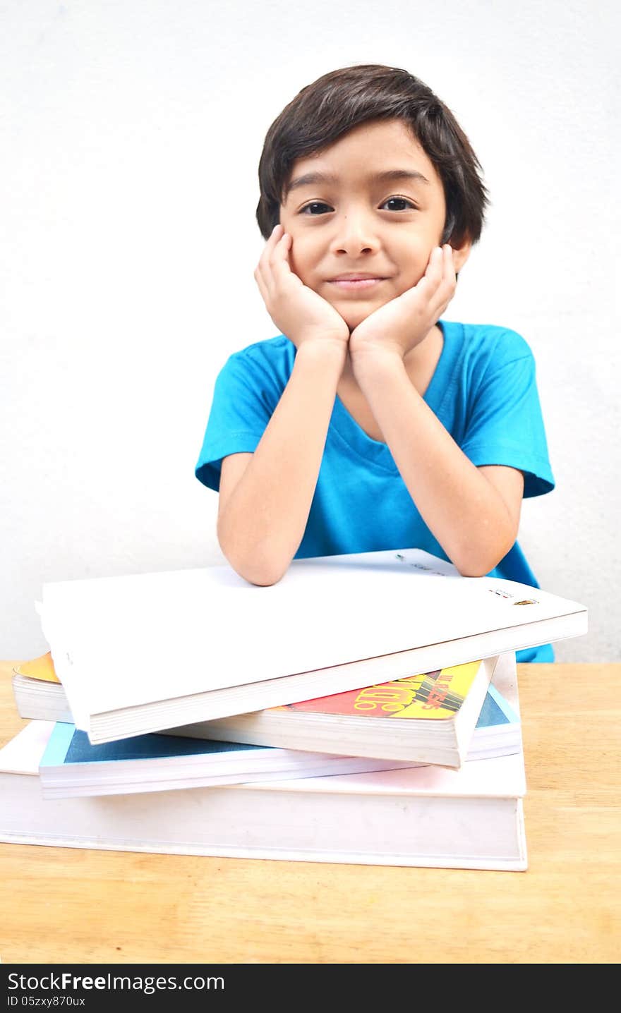 Little boy studying text books