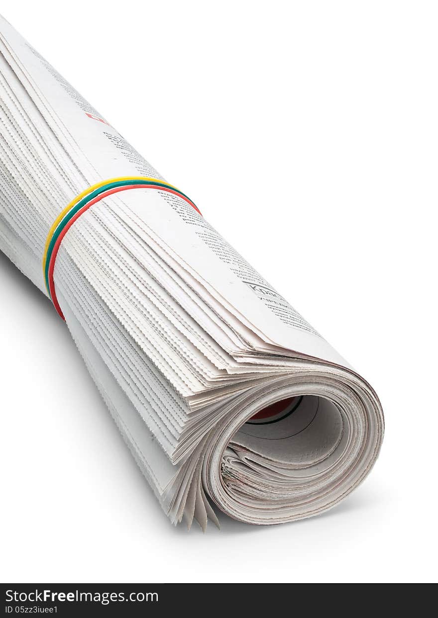 The roll of the newspapers which have been pulled together with an elastic band on a white background. The roll of the newspapers which have been pulled together with an elastic band on a white background