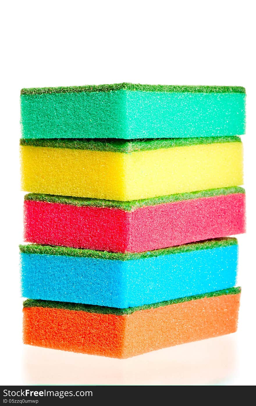 Tower of colorful sponges for ware on a white background