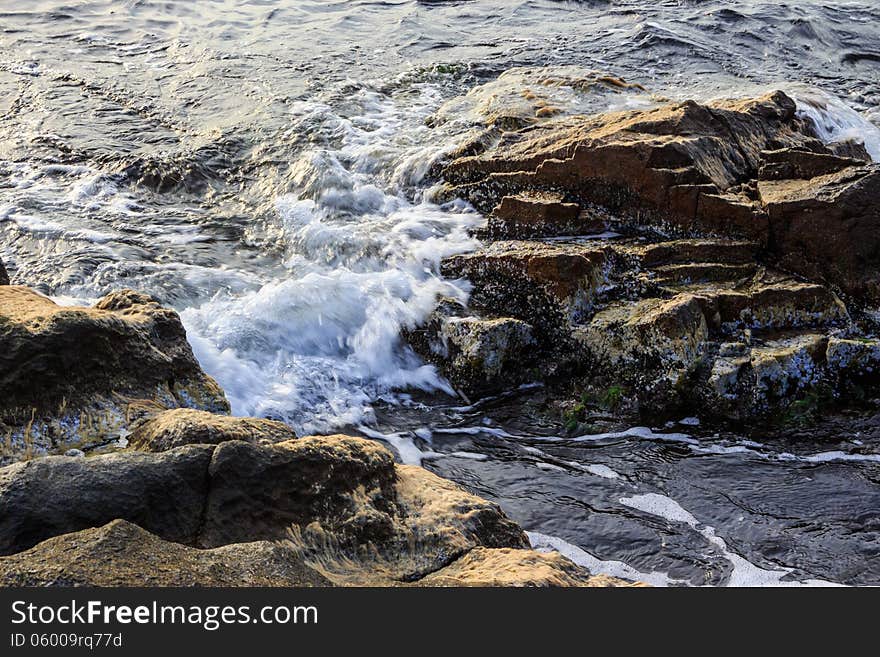 Sea ​​wave attacks the boulders and is broken about them. Sea ​​wave attacks the boulders and is broken about them