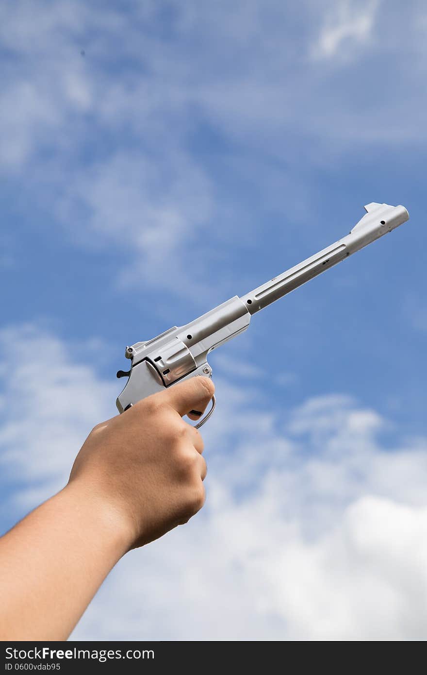 Gun in hand on sky