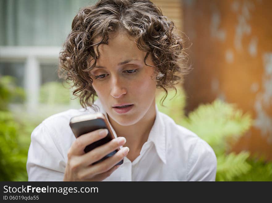 Woman receiving bad news on the phone In Front Of The House