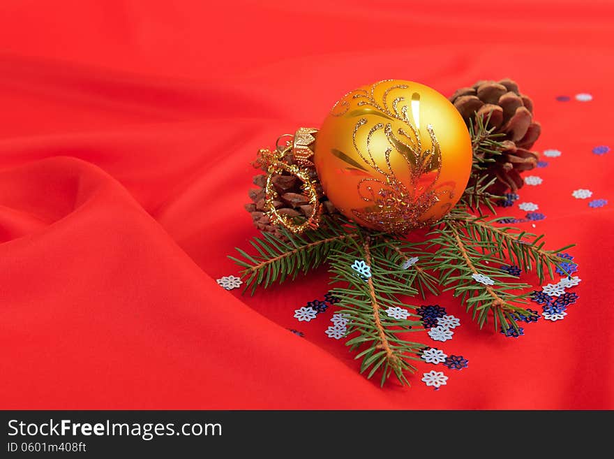 Christmas ball and pine tree branch decoration on red silk. Christmas ball and pine tree branch decoration on red silk