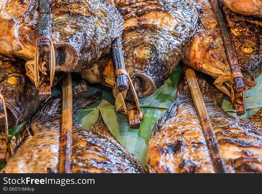 Close up of roasted fish skewers cooked with Laos style. Close up of roasted fish skewers cooked with Laos style.