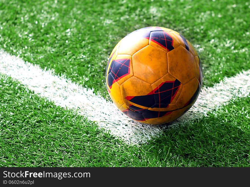 Old soccer ball on soccer field