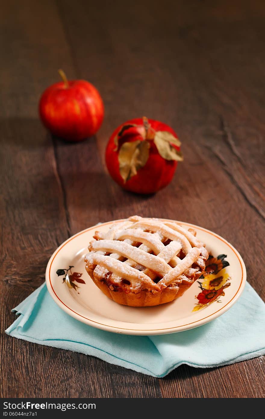 Small apple pie on wooden table