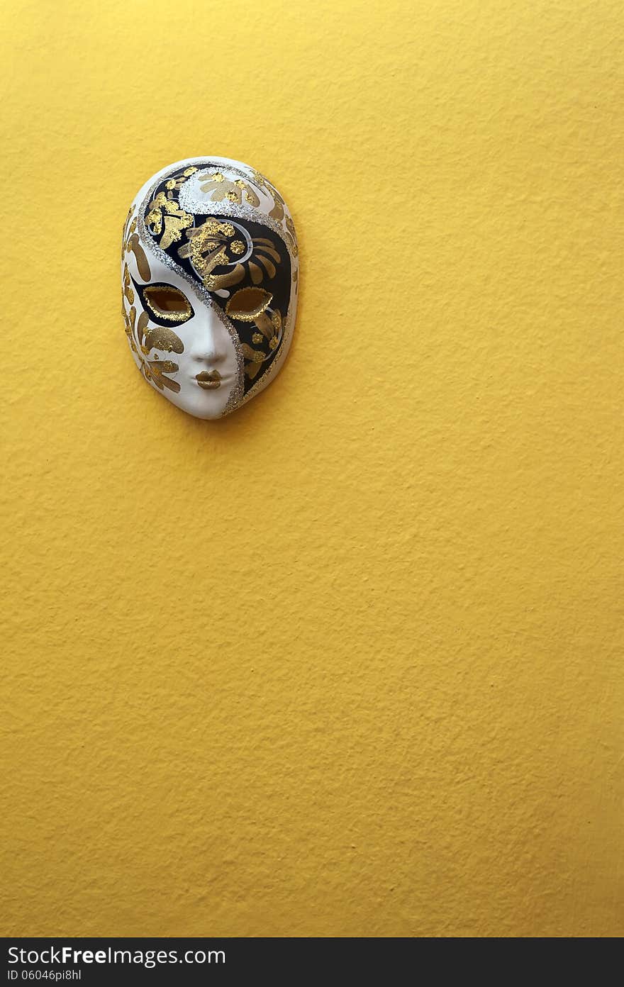 Beautiful elegant venetian mask on orange wall background