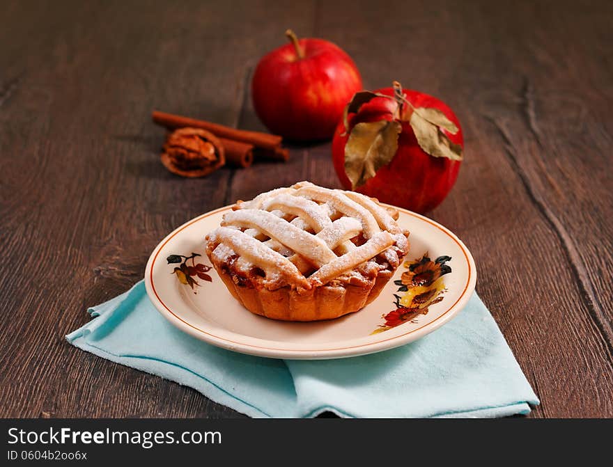 Small apple pie on wooden table