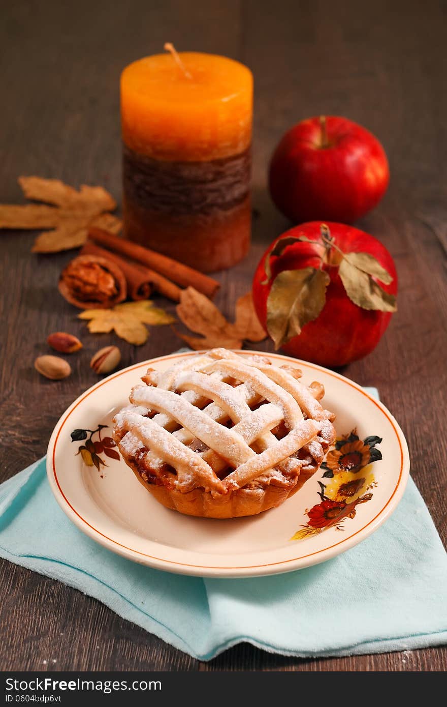 Small apple pie on wooden table