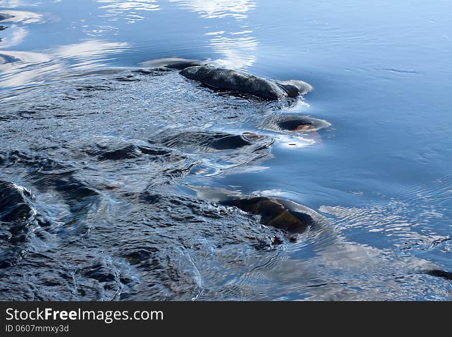 Current water with the reflection of the sky and clouds. Current water with the reflection of the sky and clouds