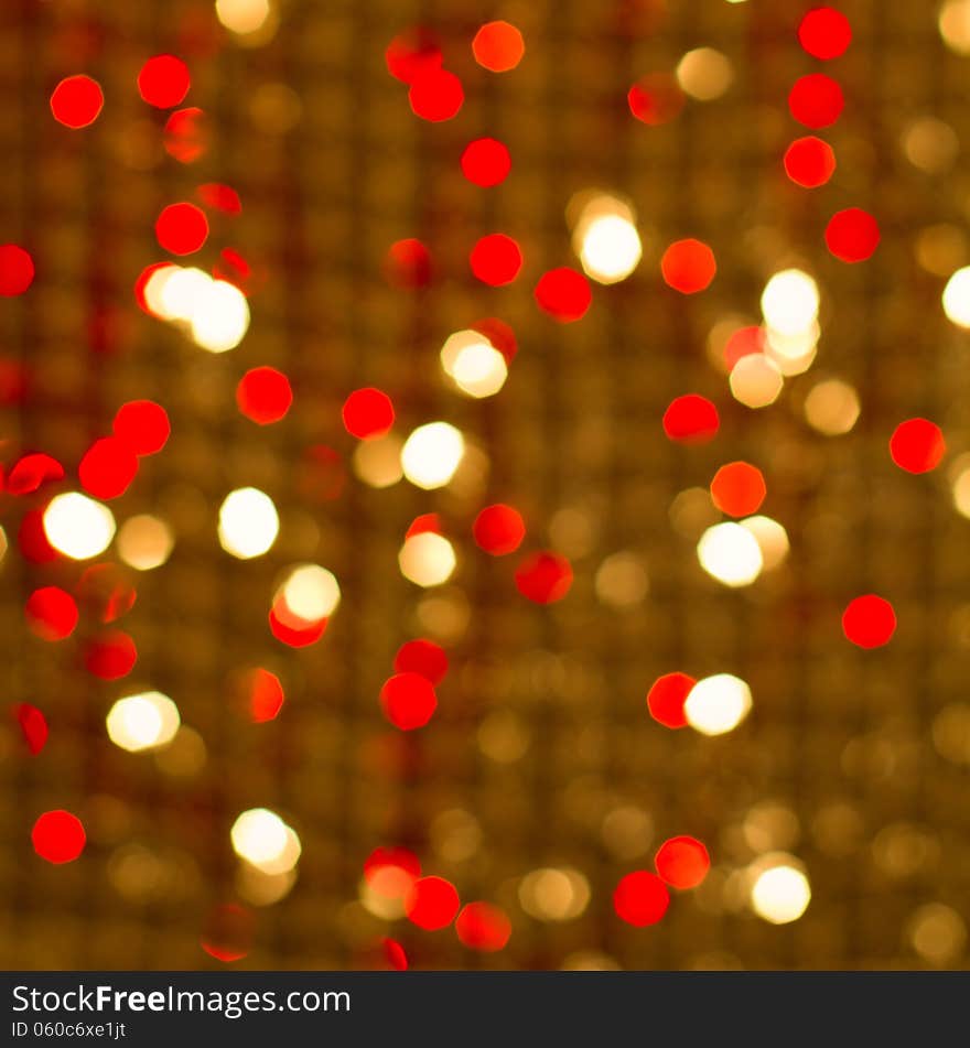 Red golden glowing background. Christmas card. Abstract background with bokeh defocused lights and stars