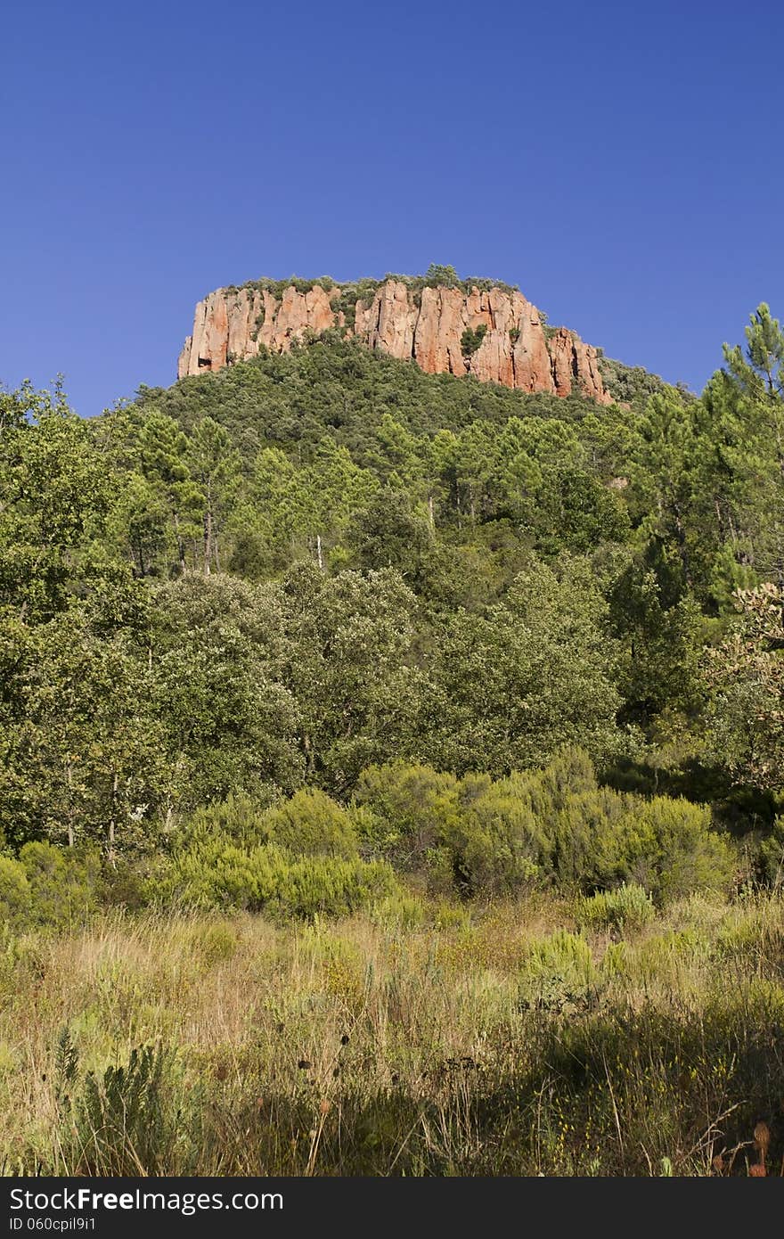 Colle Rousse, Red Rock Volcanic plug above the Blavet Gorge, Bagnols en Foret, The Var France. Colle Rousse, Red Rock Volcanic plug above the Blavet Gorge, Bagnols en Foret, The Var France