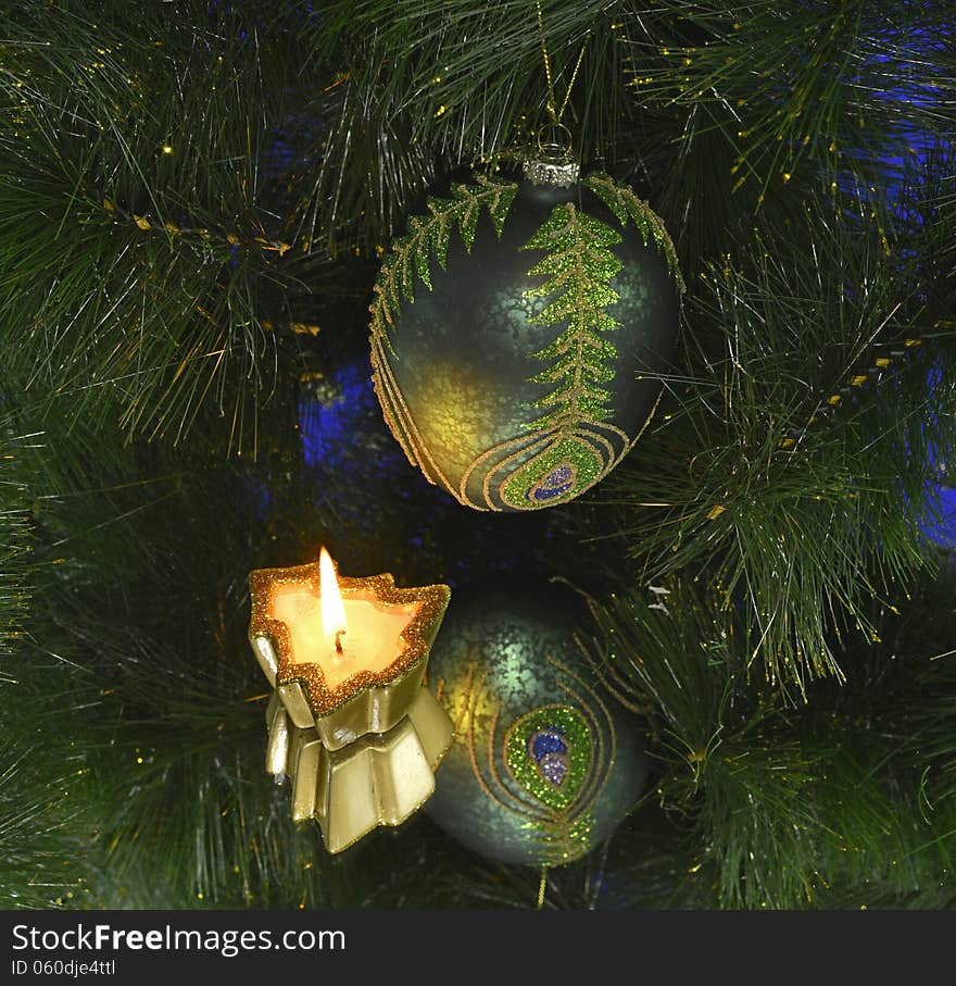 Green toy with burning candle and conifer on mirror. Green toy with burning candle and conifer on mirror