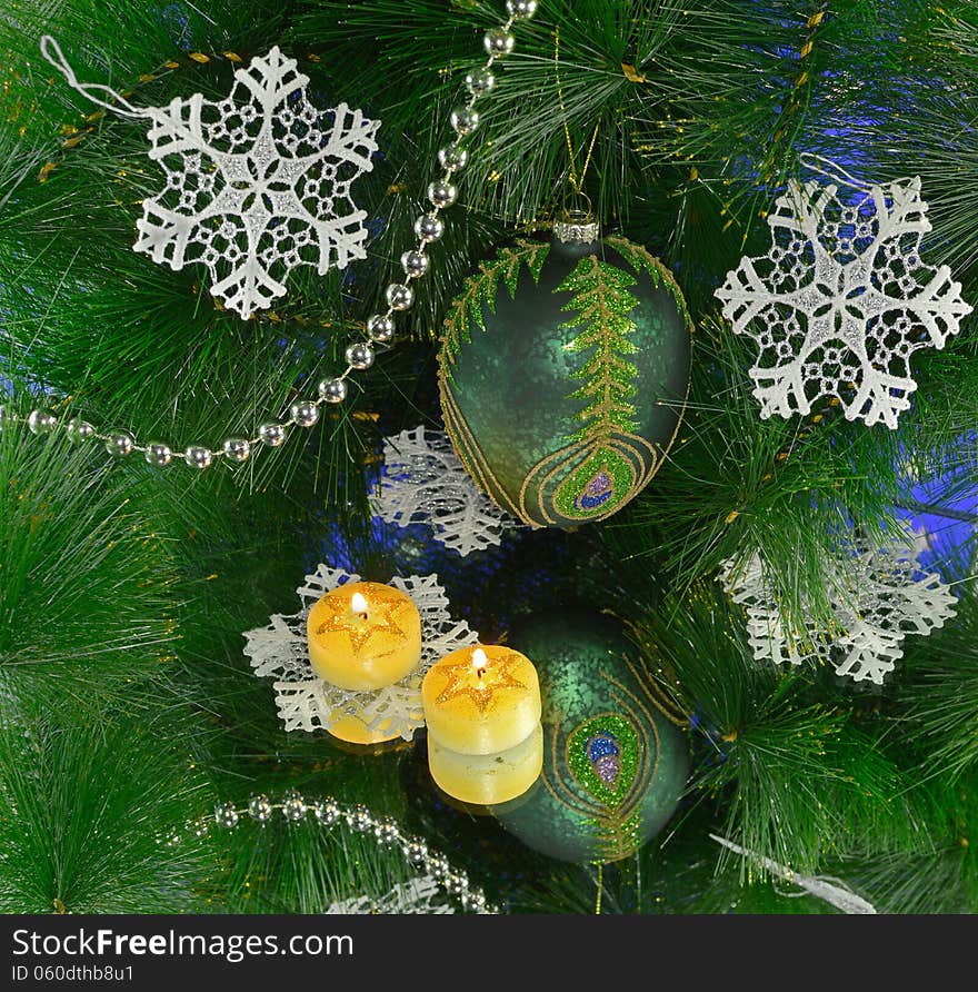 Green tow with two candles and white snowflakes on mirror. Green tow with two candles and white snowflakes on mirror