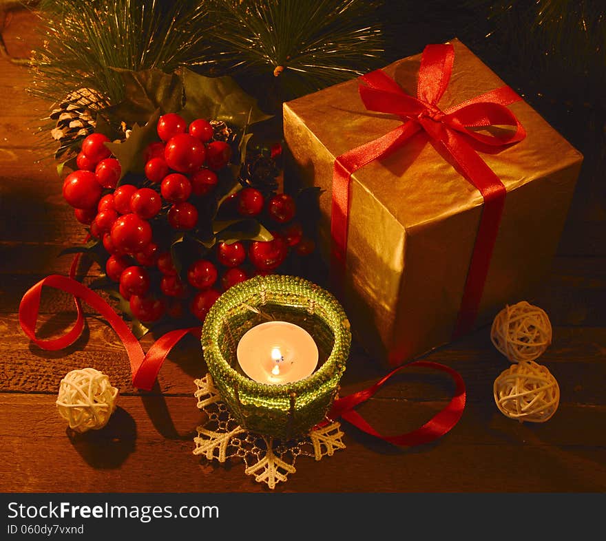 Golden box with ilex and candle