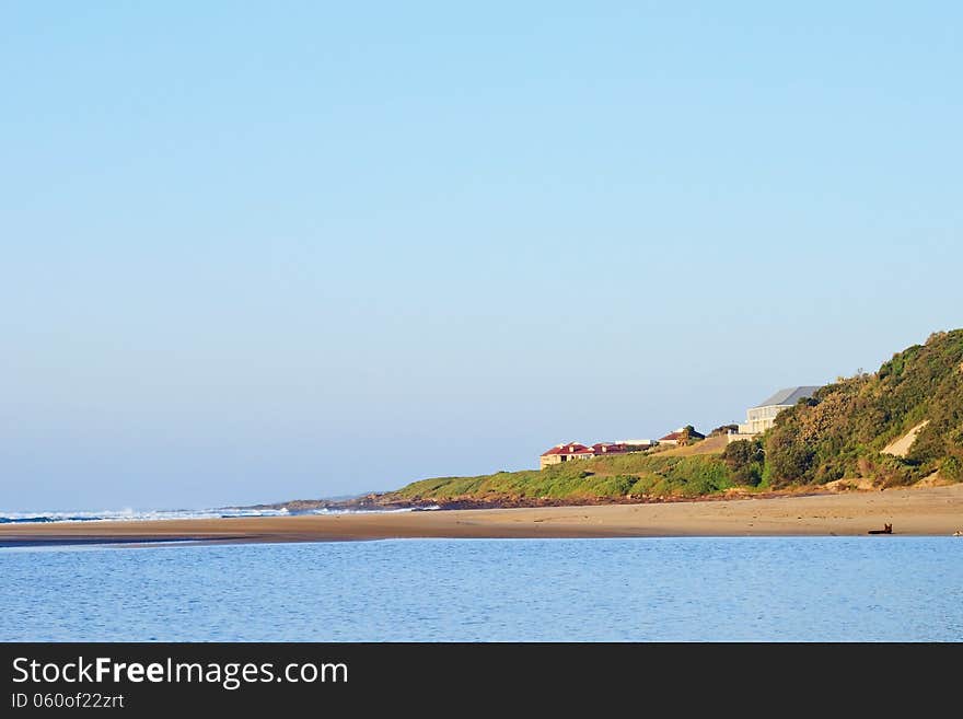 Houses on the beach on East Coast of South Africa in bright early morning sunlight. Houses on the beach on East Coast of South Africa in bright early morning sunlight