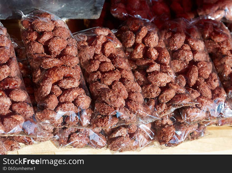 Heap of sweet roasted almonds glazed with sugar in a market