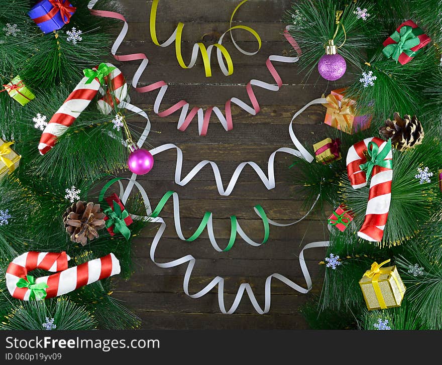 Christmas background with toys, baubles and conifer on wooden background. Christmas background with toys, baubles and conifer on wooden background